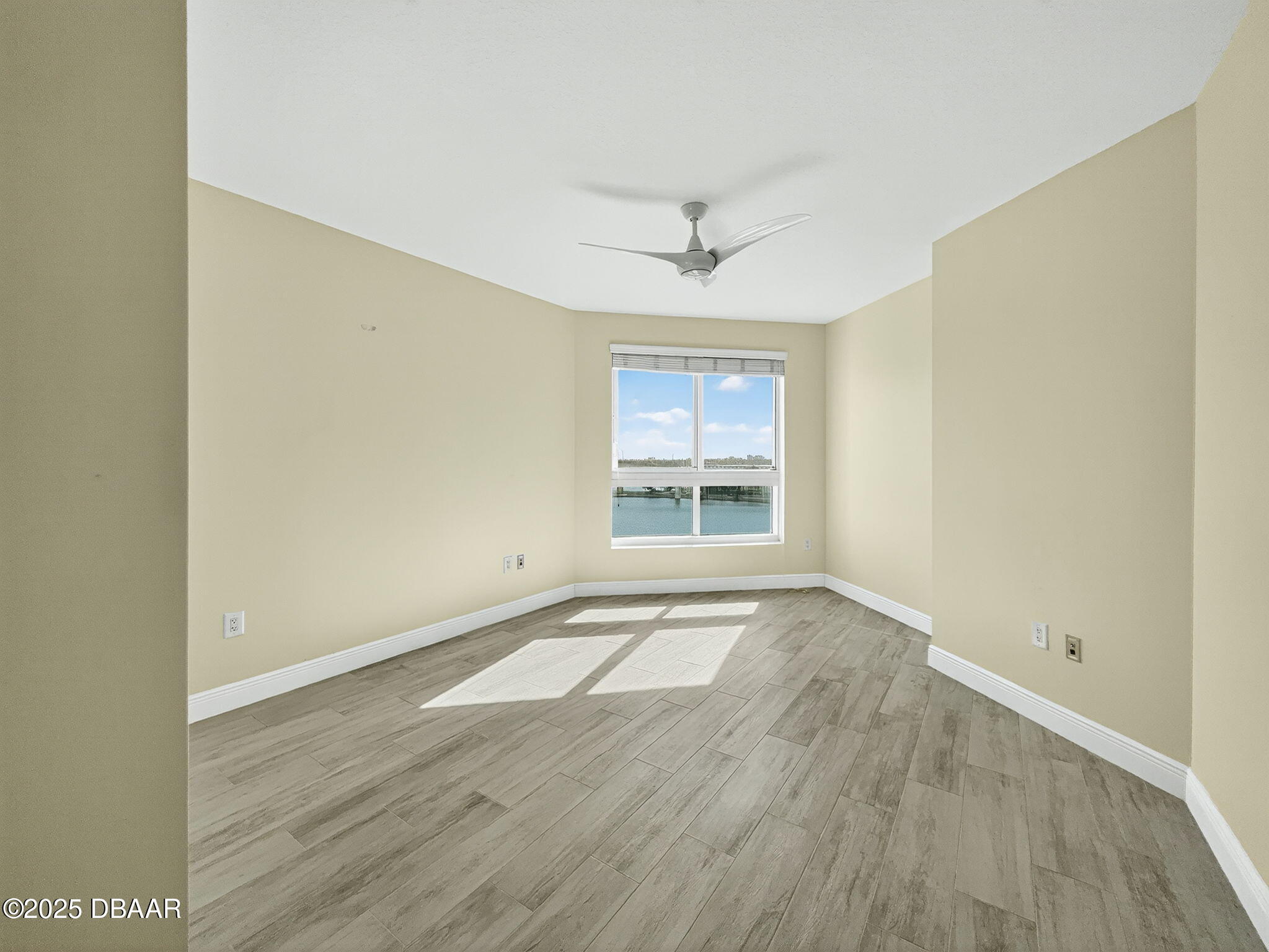 231 Riverside Drive, Unit 903 Holly Hill, FL 32117 - Photo 16 of 28 an empty room with wooden floor chandelier and windows