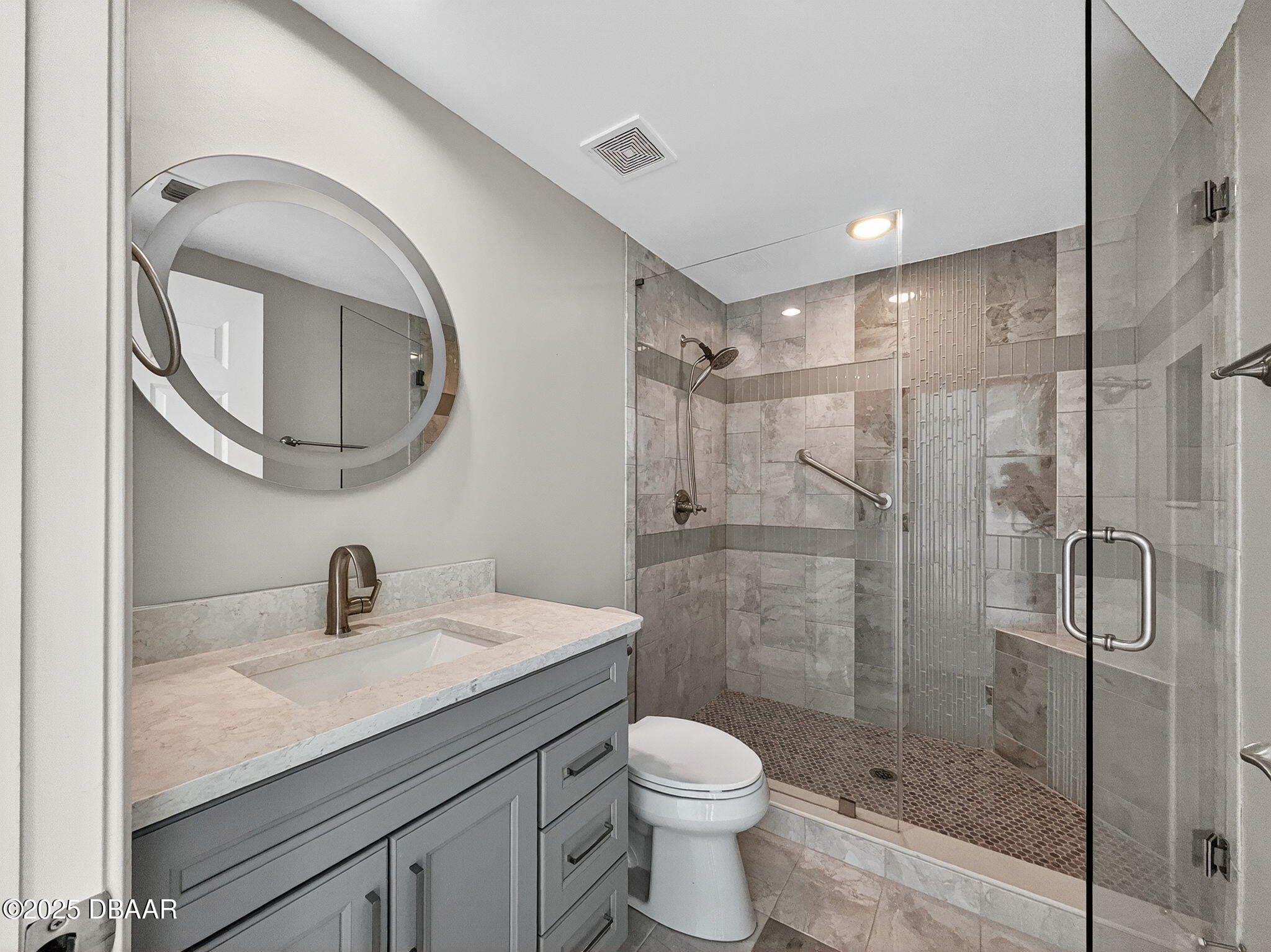 231 Riverside Drive, Unit 903 Holly Hill, FL 32117 - Photo 17 of 28 a bathroom with a granite countertop sink toilet and shower