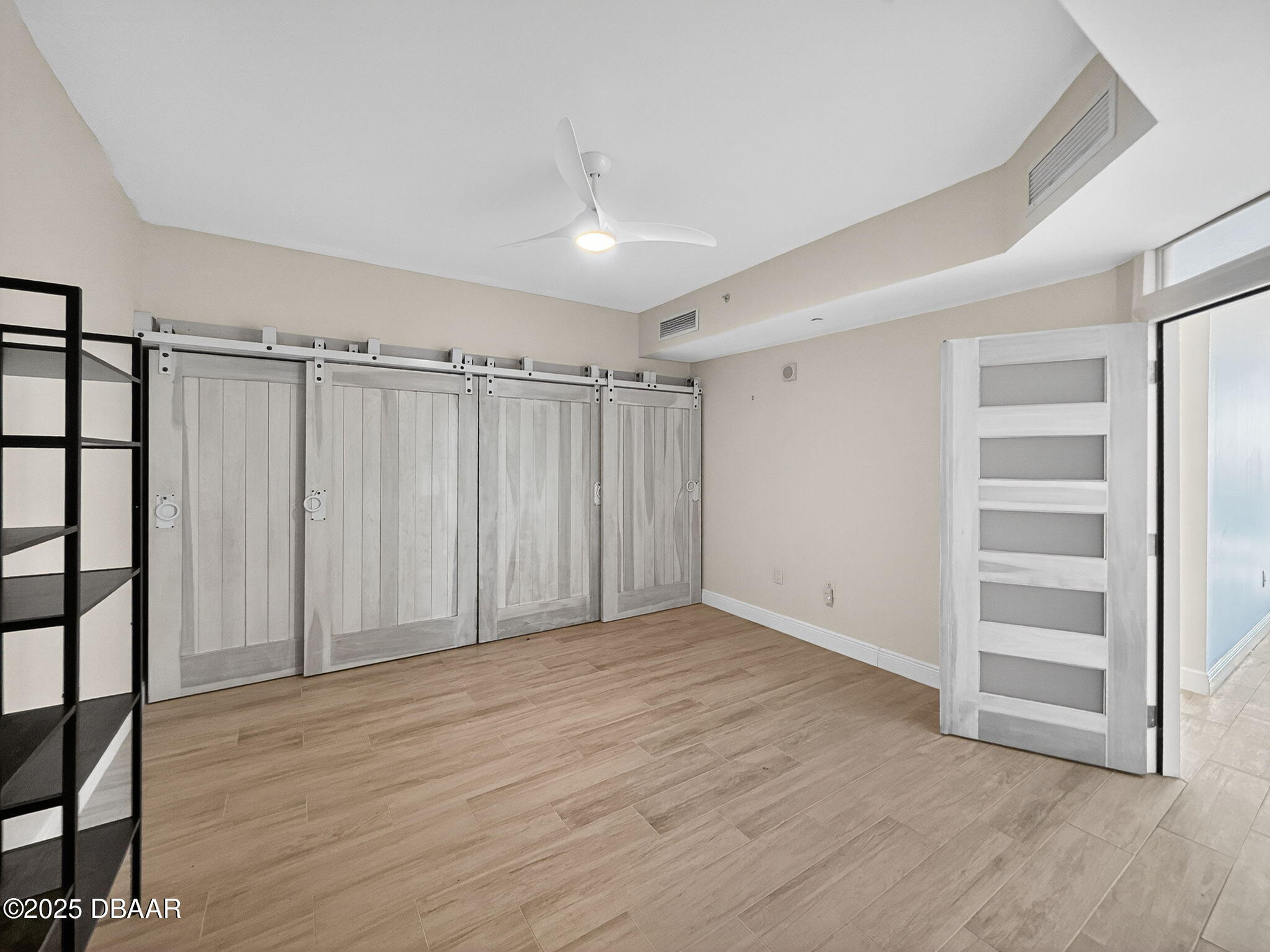 231 Riverside Drive, Unit 903 Holly Hill, FL 32117 - Photo 21 of 28 a view of an empty room with wooden floor and entryway