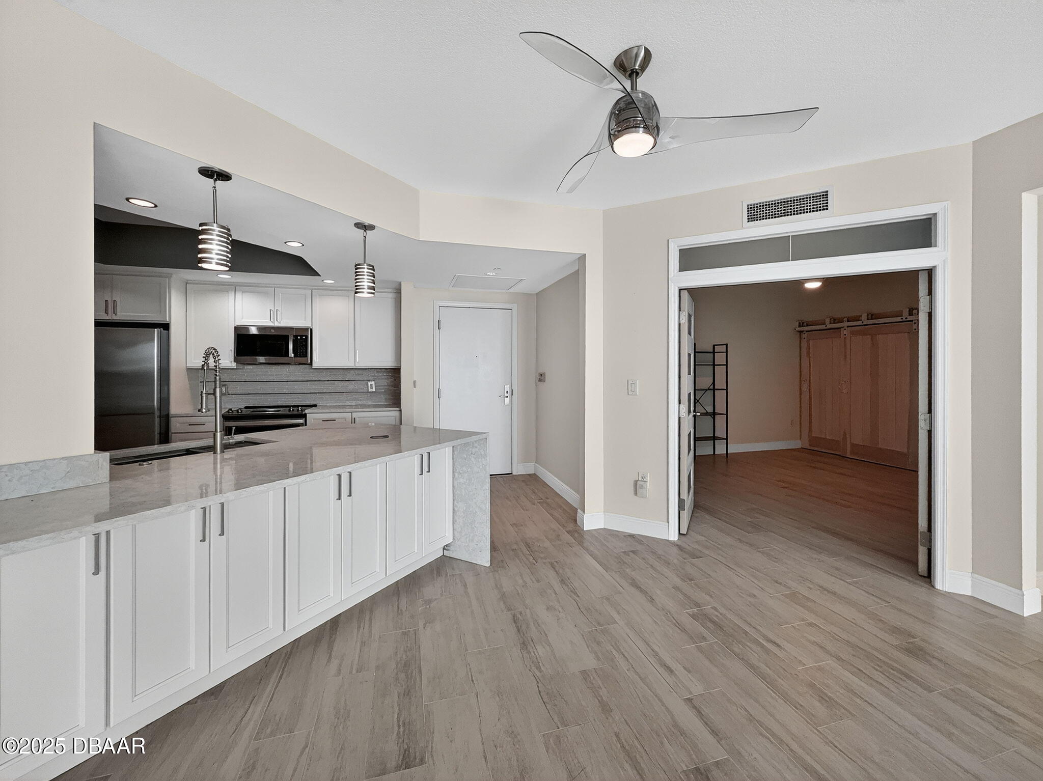 231 Riverside Drive, Unit 903 Holly Hill, FL 32117 - Photo 23 of 28 a kitchen with stainless steel appliances a refrigerator and a stove top oven
