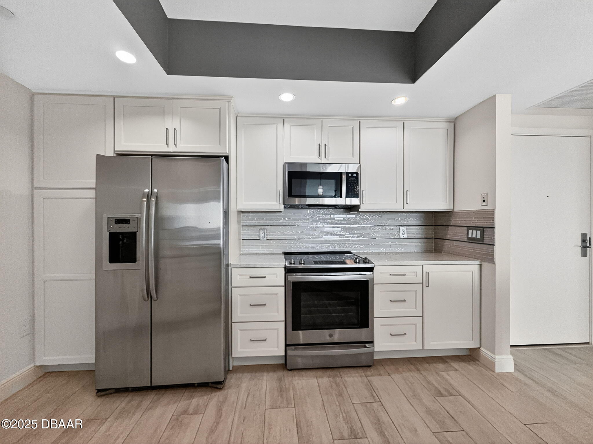 231 Riverside Drive, Unit 903 Holly Hill, FL 32117 - Photo 26 of 28 a kitchen with stainless steel appliances a refrigerator sink and microwave