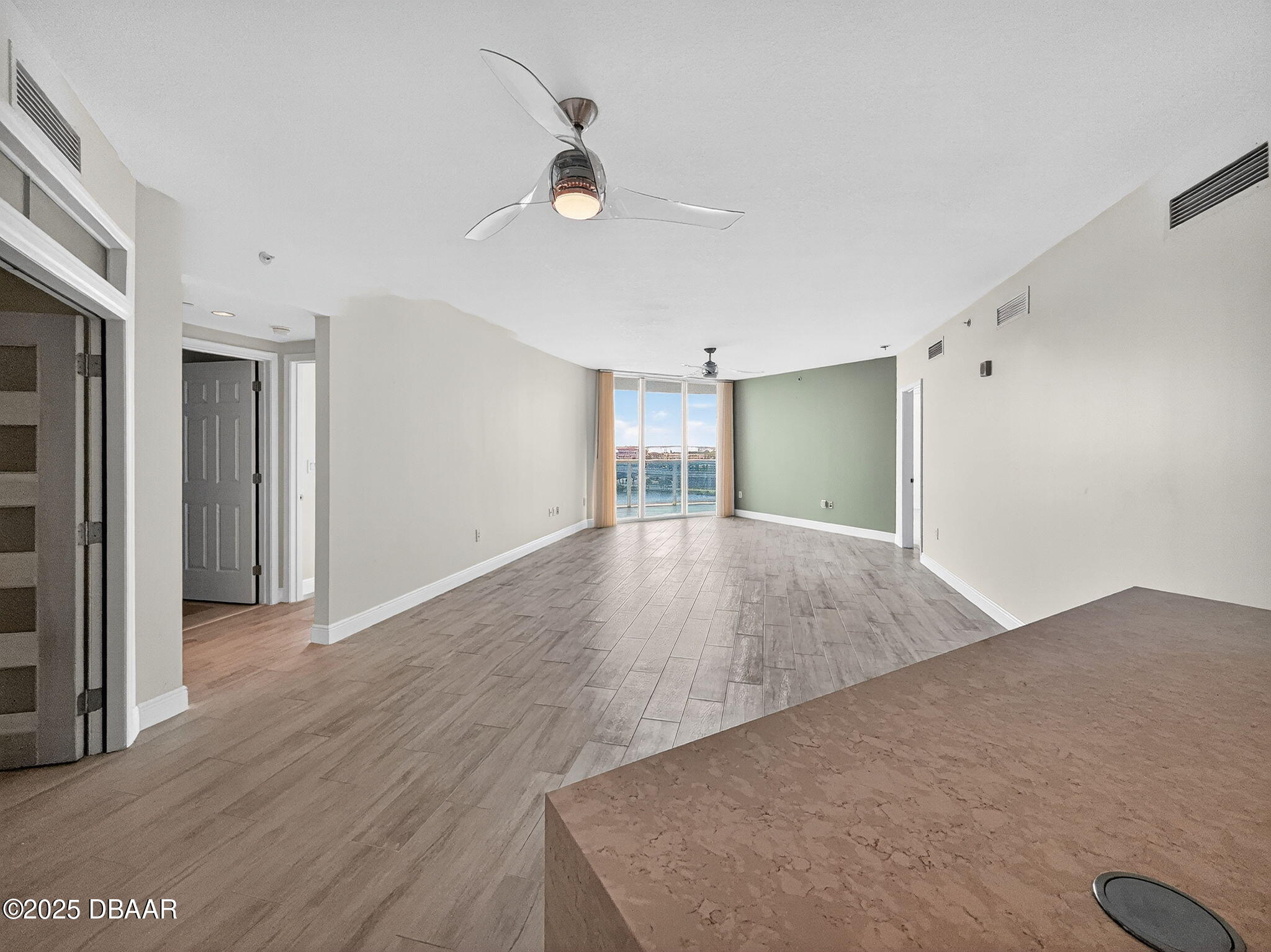 231 Riverside Drive, Unit 903 Holly Hill, FL 32117 - Photo 3 of 28 a view of a big room with wooden floor and cabinet