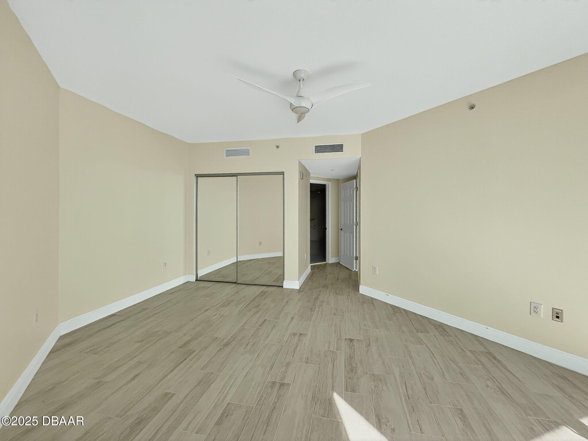 231 Riverside Drive, Unit 903 Holly Hill, FL 32117 - Photo 9 of 28 a view of an empty room with wooden floor
