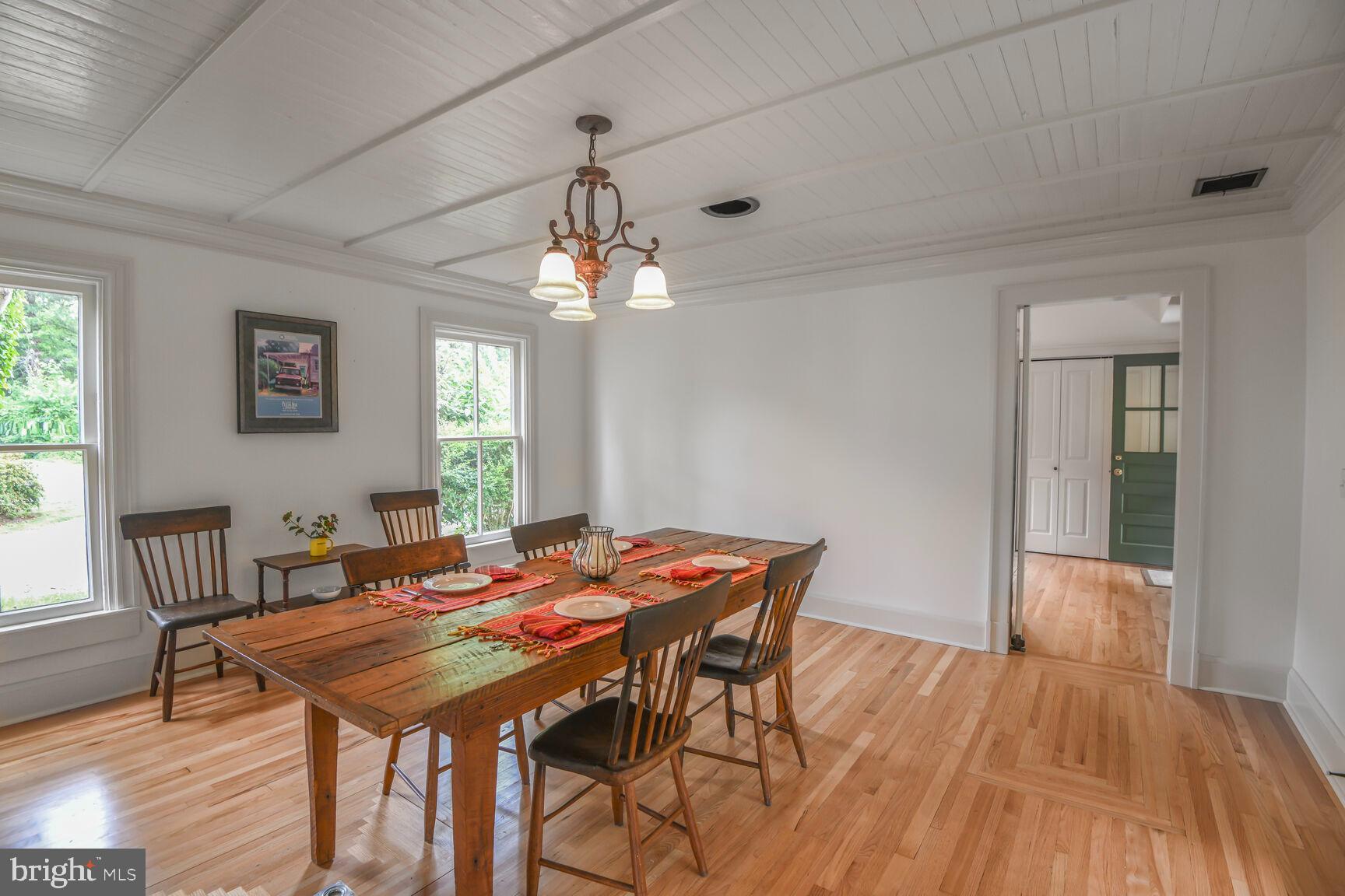 7651 Main Street Tilghman, MD 21671 - Photo 18 of 35 a view of a dining room with furniture and wooden floor