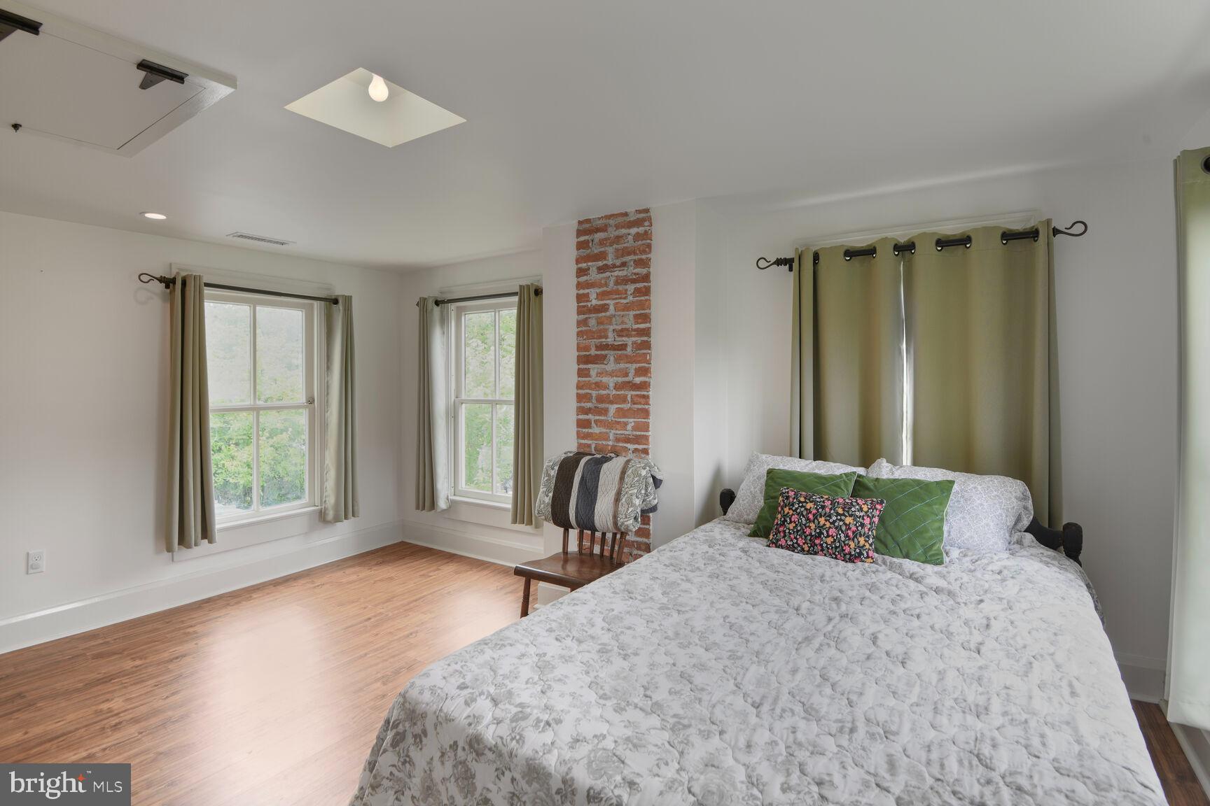 7651 Main Street Tilghman, MD 21671 - Photo 28 of 35 a bedroom with a large bed and a large window