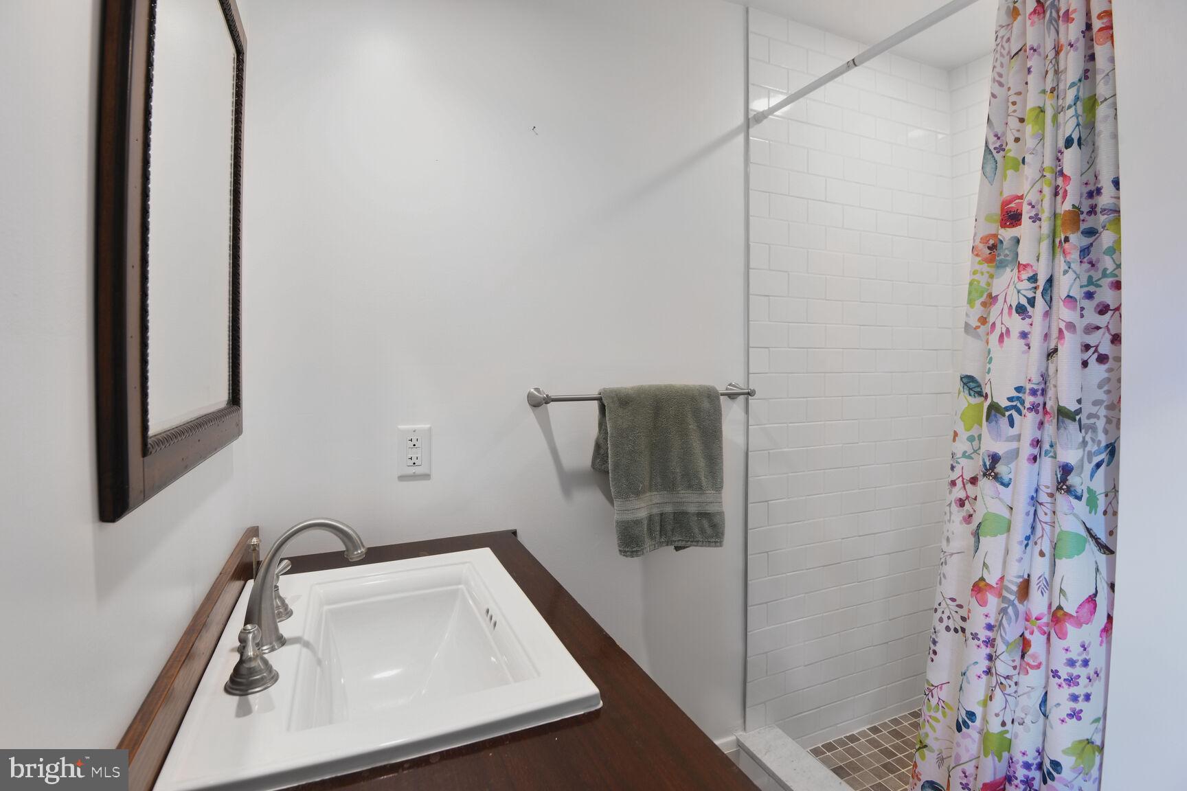 7651 Main Street Tilghman, MD 21671 - Photo 31 of 35 a bathroom with a sink and mirror with toilet