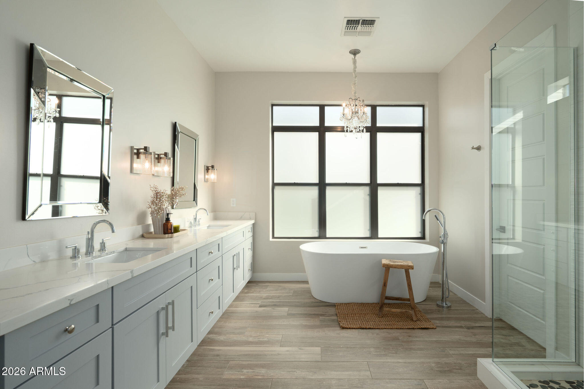 4533 East Montecito Avenue Phoenix, AZ 85018 - Photo 18 of 29 a spacious bathroom with a double vanity sink a large mirror and a bathtub