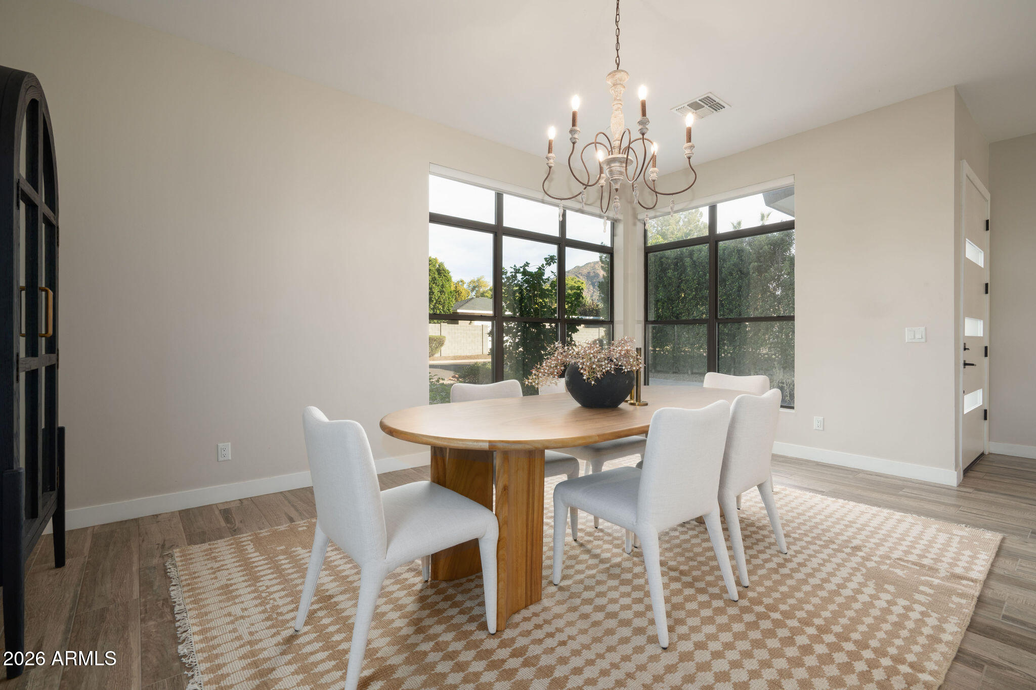 4533 East Montecito Avenue Phoenix, AZ 85018 - Photo 2 of 29 a view of a dining room with furniture a chandelier and wooden floor