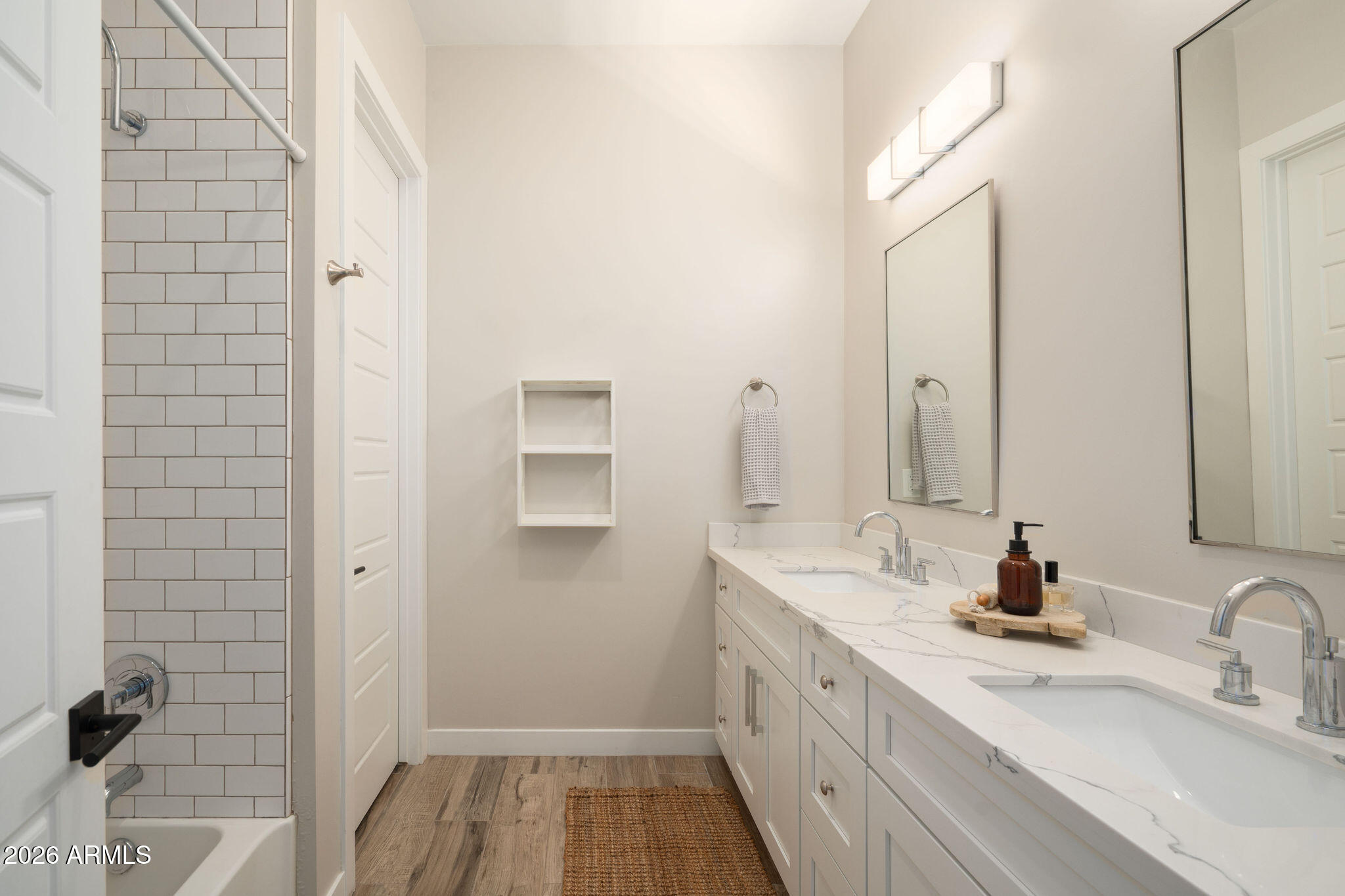4533 East Montecito Avenue Phoenix, AZ 85018 - Photo 23 of 29 a bathroom with a double vanity sink a mirror and shower