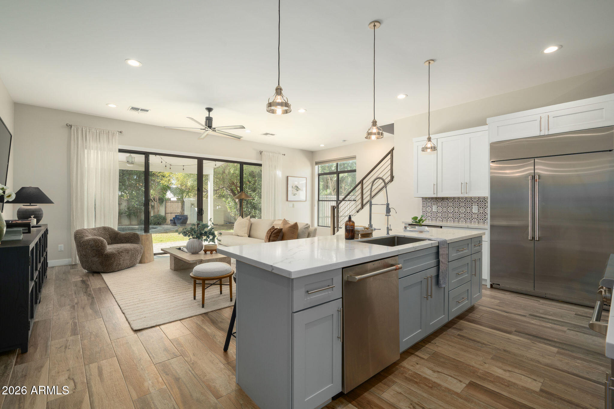 4533 East Montecito Avenue Phoenix, AZ 85018 - Photo 9 of 29 a large kitchen with kitchen island a large counter space a sink appliances and cabinets