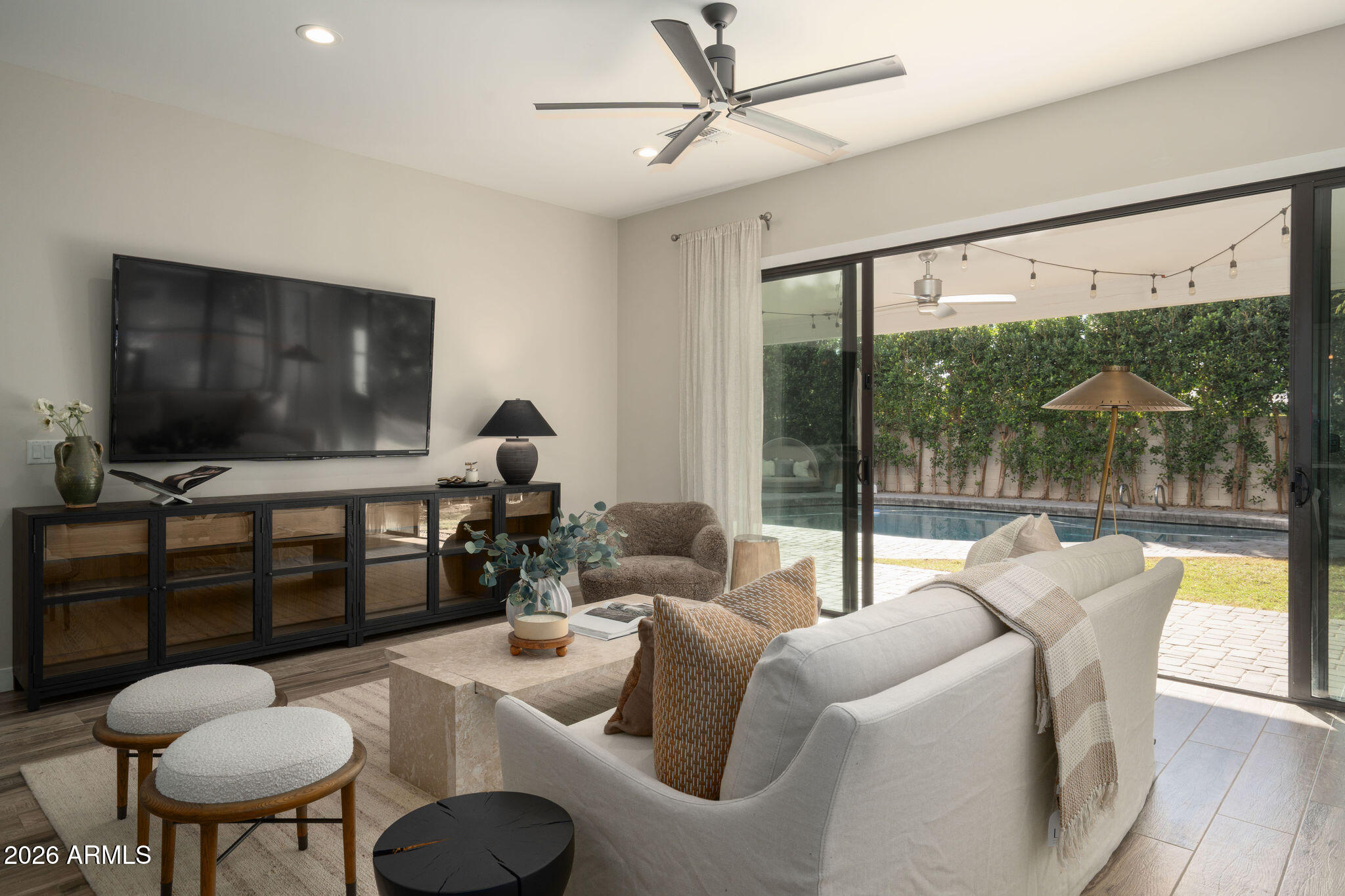 4533 East Montecito Avenue Phoenix, AZ 85018 - Photo 10 of 29 a living room with furniture a flat screen tv and a floor to ceiling window