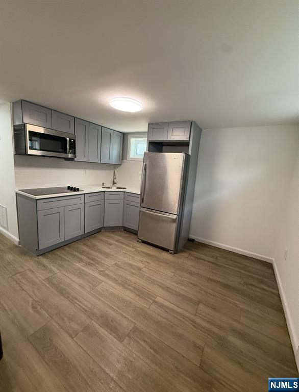 a kitchen with stainless steel appliances granite countertop a refrigerator sink and microwave