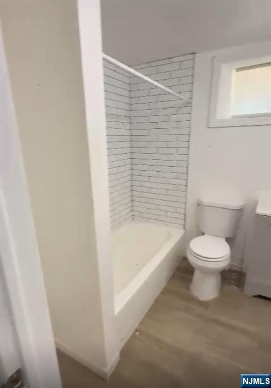 100 Rosa Parks Boulevard, Unit B1BY Paterson, NJ 07501 - Photo 6 of 10 a bathroom with a toilet and a bathtub