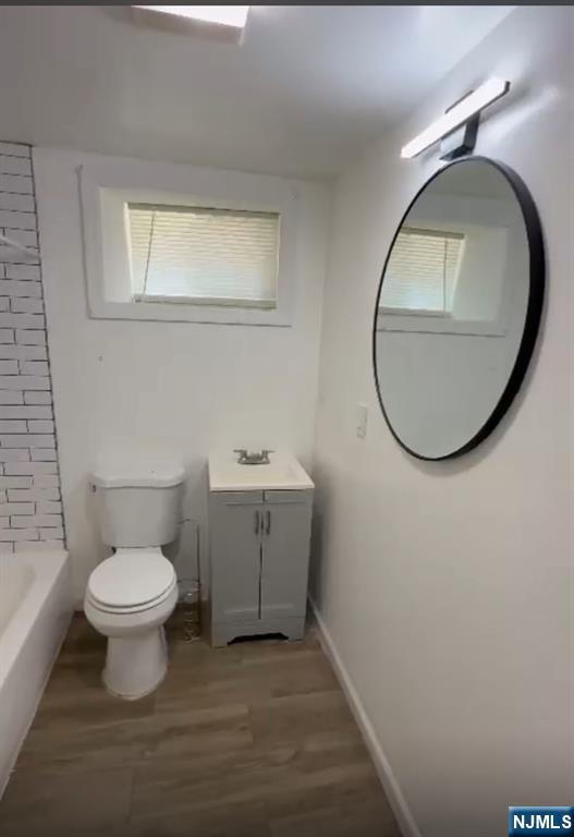 100 Rosa Parks Boulevard, Unit B1BY Paterson, NJ 07501 - Photo 7 of 10 a bathroom with a toilet sink and a mirror