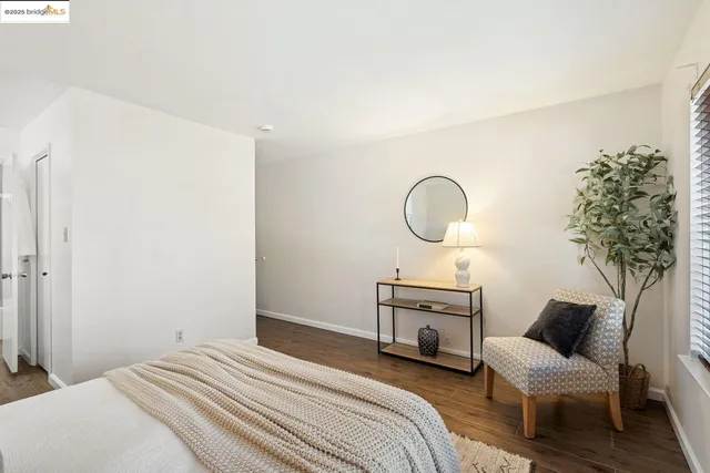a bedroom with a bed and a potted plant