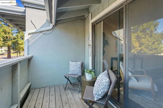 a view of a balcony with furniture