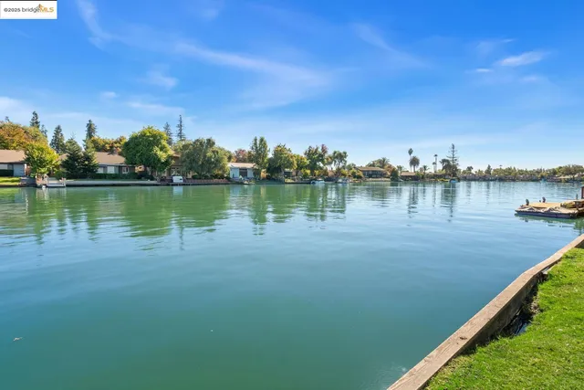 a view of a lake with houses in the back