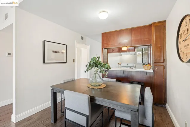 a dining room with furniture and wooden floor