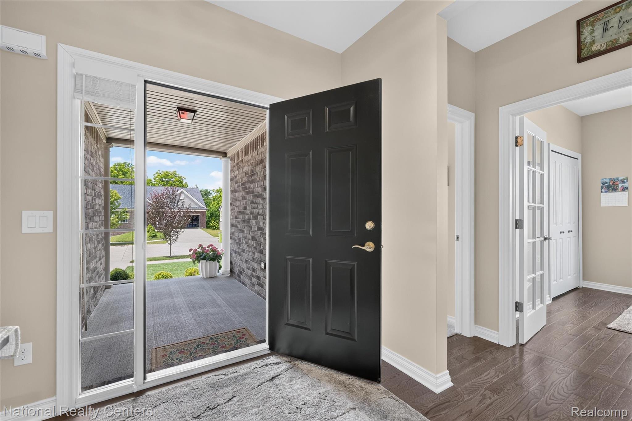 740 North Mill Street South Lyon, MI 48178 - Photo 10 of 56 Inviting entryway featuring a dark wood-finish door, light-toned walls, and dark wood-finish flooring