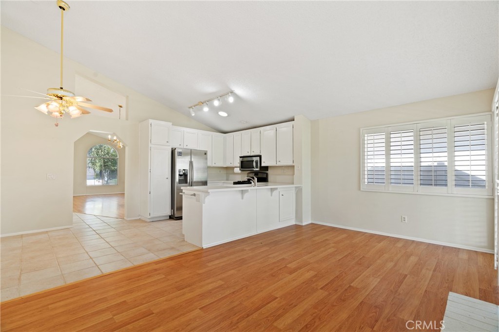5772 Riviera Avenue Banning, CA 92220 - Photo 14 of 60 a kitchen with kitchen island a sink stainless steel appliances and cabinets