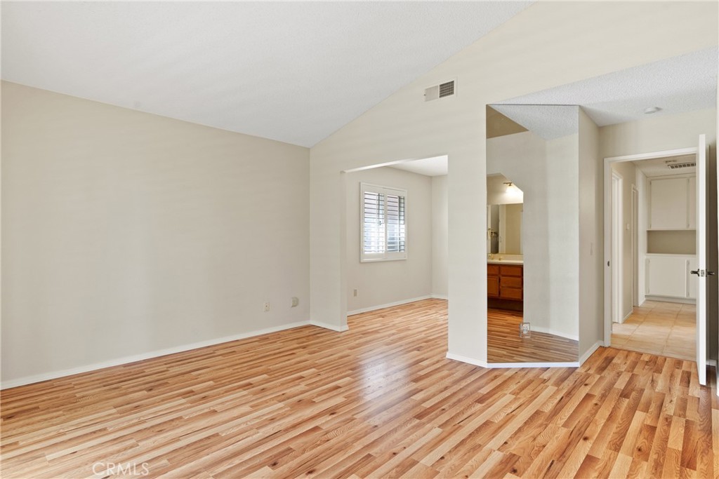 5772 Riviera Avenue Banning, CA 92220 - Photo 27 of 60 a view of an empty room with wooden floor and a window