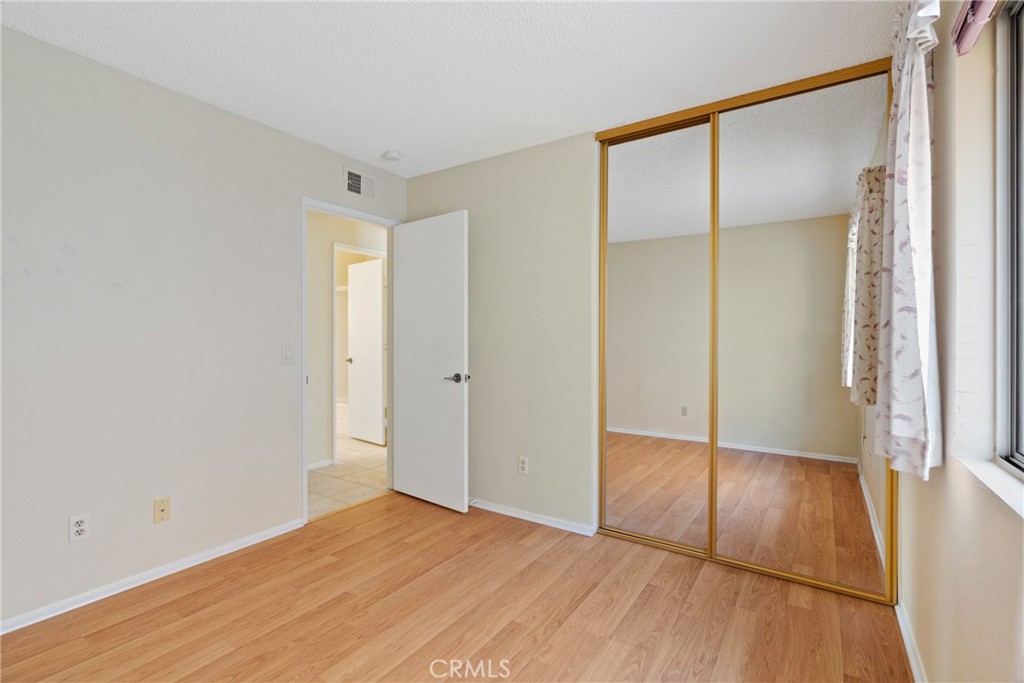 5772 Riviera Avenue Banning, CA 92220 - Photo 34 of 60 a view of an empty room with wooden floor and a window