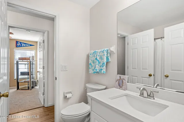 a view of a workspace with furniture and a ceiling fan