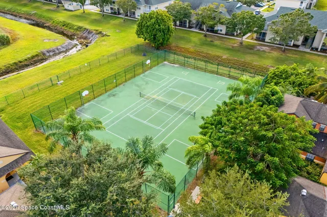 a green field with trees in the background