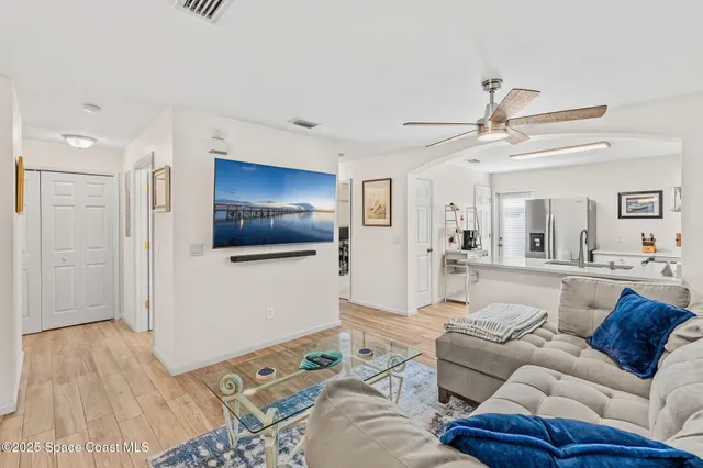 a living room with furniture a dining table and wooden floor