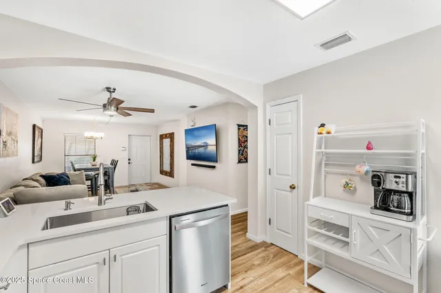 a bedroom with a bed and a chandelier fan