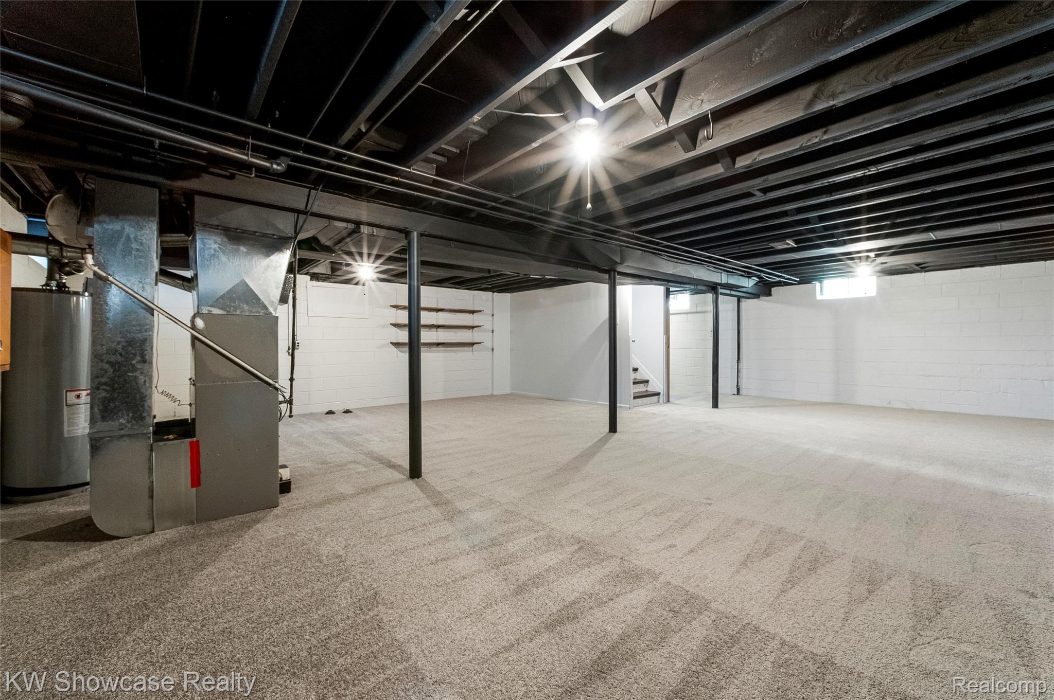 8936 Merriman Road Livonia, MI 48150 - Photo 45 of 49 Spacious basement with light grey carpeting and white block walls