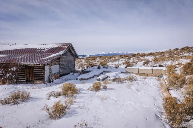 a view of a house with a yard covered with snow in front of house