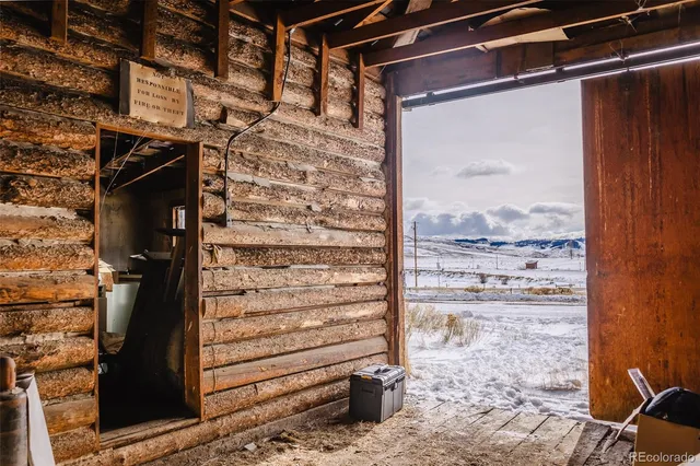 a view of a dry yard with wooden fence