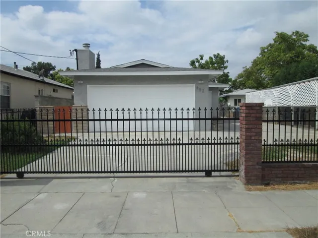 a view of a wrought iron fences in front of house