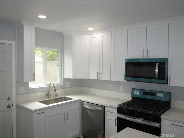 a kitchen with a sink and a stove top oven