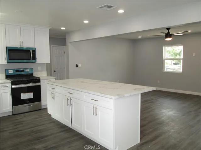 a kitchen with a stove a sink and a microwave