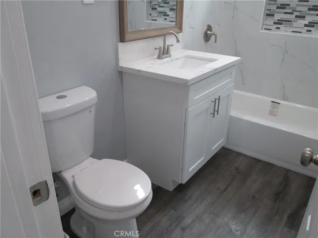 a bathroom with a sink toilet and vanity