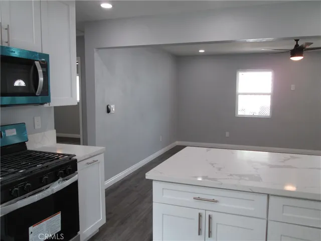 a kitchen with a sink and a stove top oven