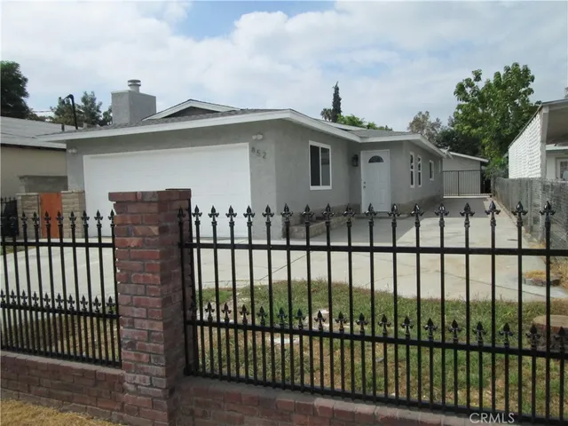 a front view of a house with a wooden fence
