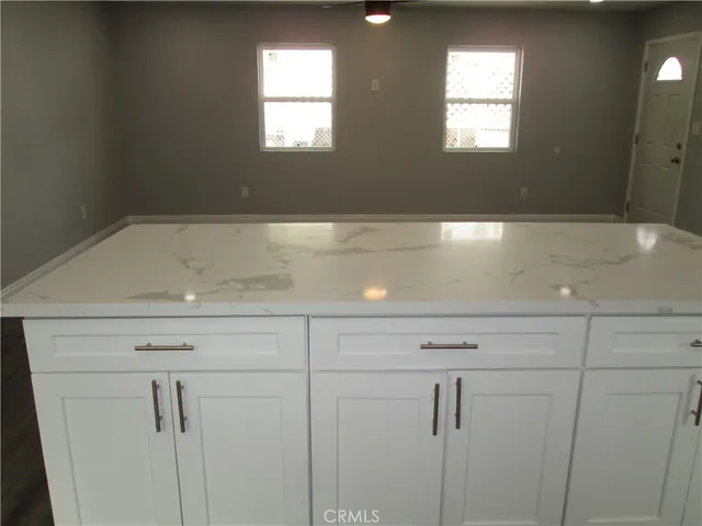 a view of white cabinets and a window