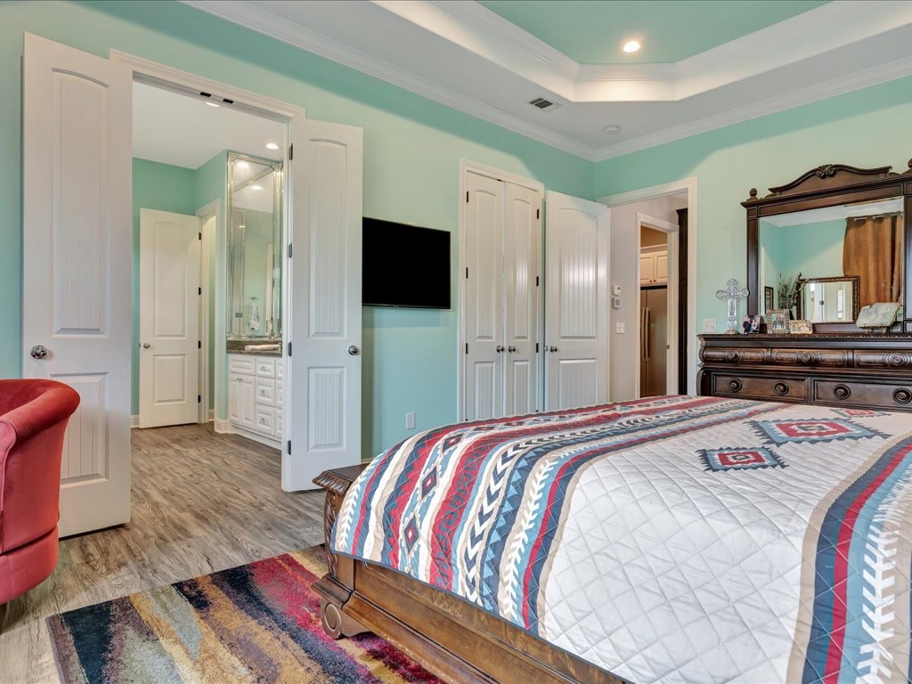 104 Wheeler Road Lufkin, TX 75901 - Photo 19 of 45 a spacious bedroom with a bed and a flat screen tv