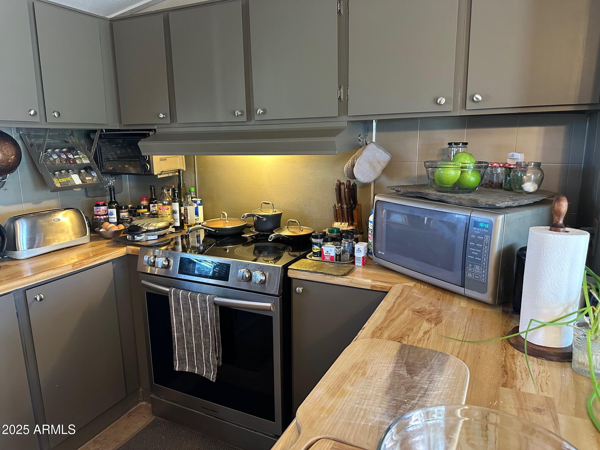 8362 North Dead Mans Gulch Road Florence, AZ 85132 - Photo 54 of 62 a kitchen with stainless steel appliances granite countertop a sink stove and cabinets