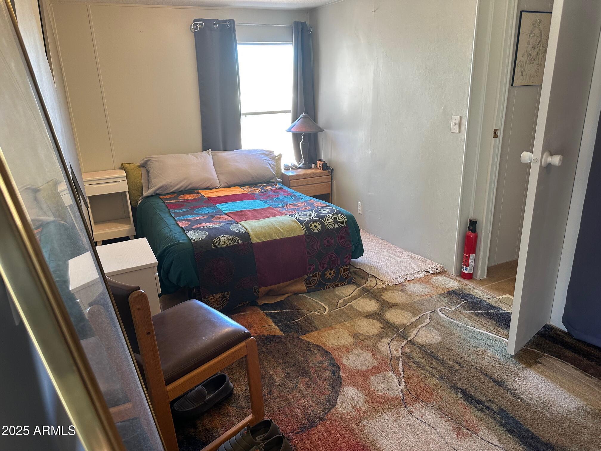 8362 North Dead Mans Gulch Road Florence, AZ 85132 - Photo 61 of 62 a bedroom with a bed and wooden floor