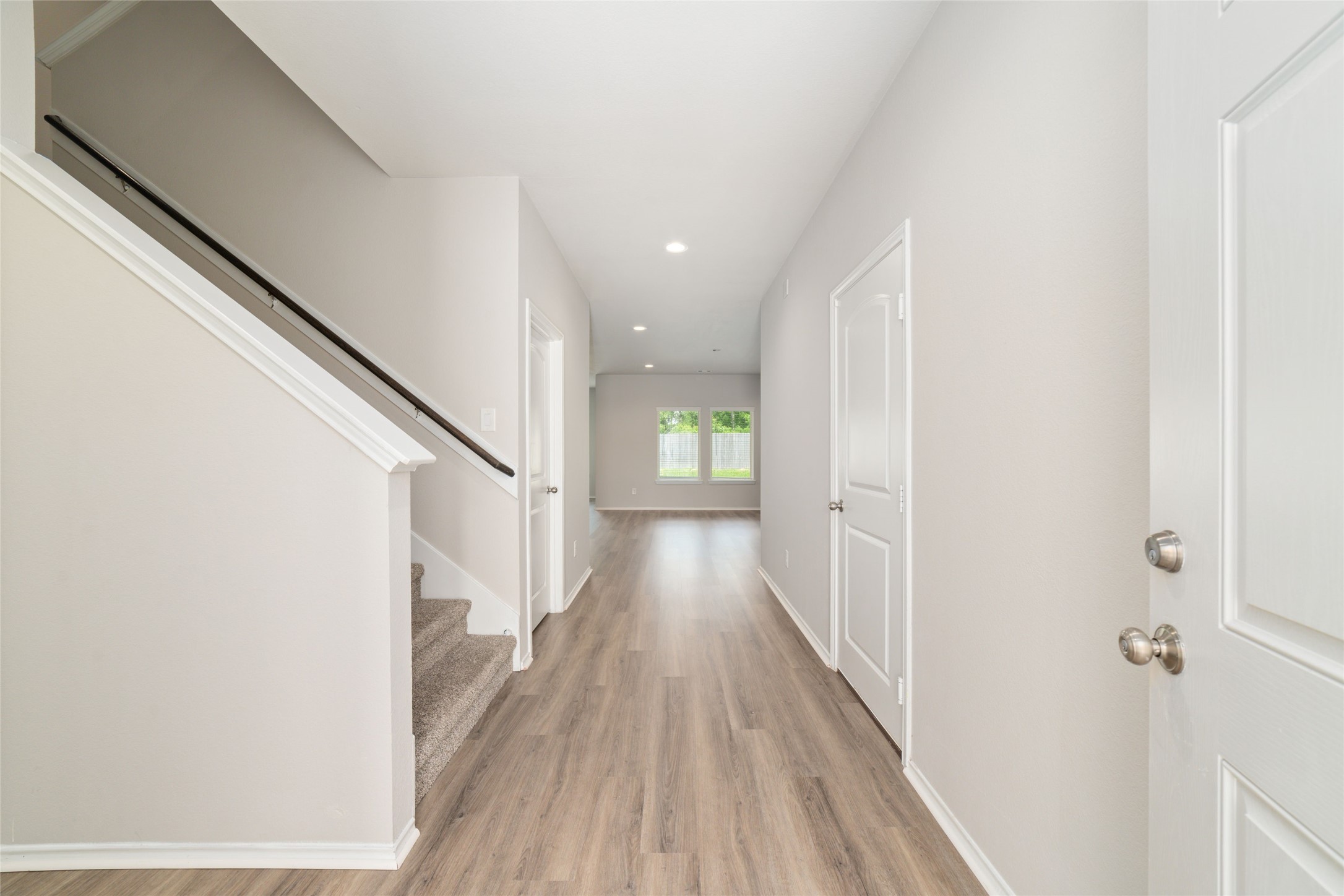 23702 Harrow Field Ln Spring Spring, TX 77373 - Photo 4 of 32 a view of a hallway with wooden floor and staircase