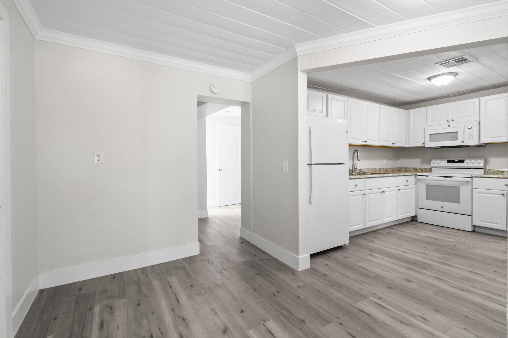 1301 West 25th Street Riviera Beach, FL 33404 - Photo 5 of 34 a view of kitchen with wooden floor