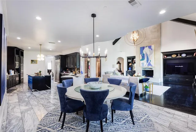 a large kitchen with a table and chairs