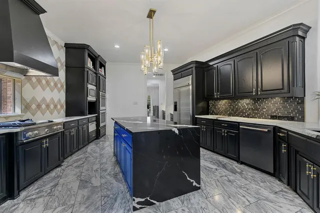 a kitchen with kitchen island granite countertop a sink stove and refrigerator