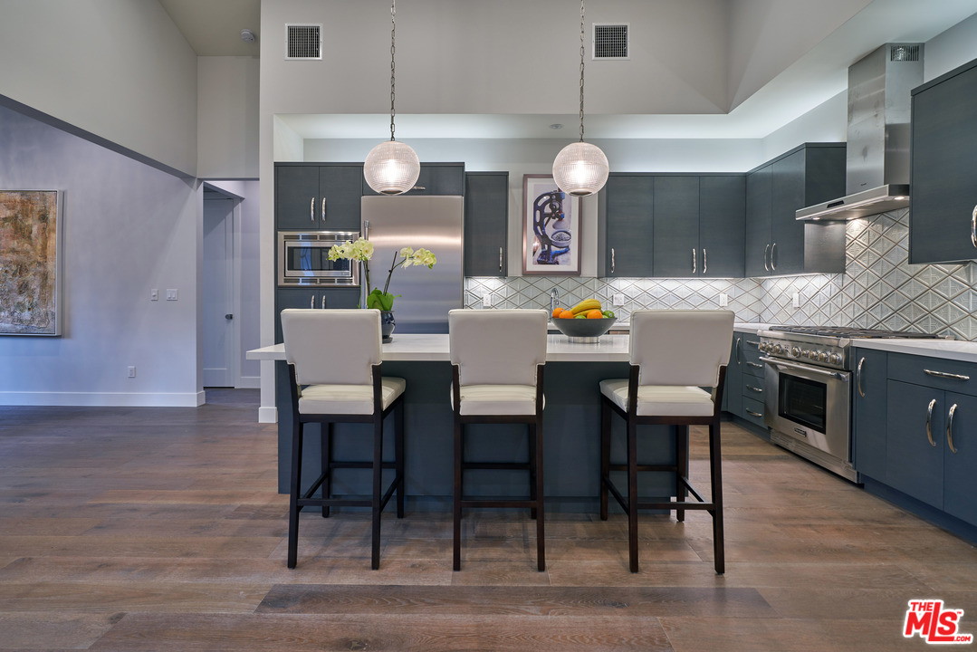 11622 Addison Street Valley Village, CA 91601 - Photo 13 of 39 a view of a dining room with furniture wooden floor and chandelier