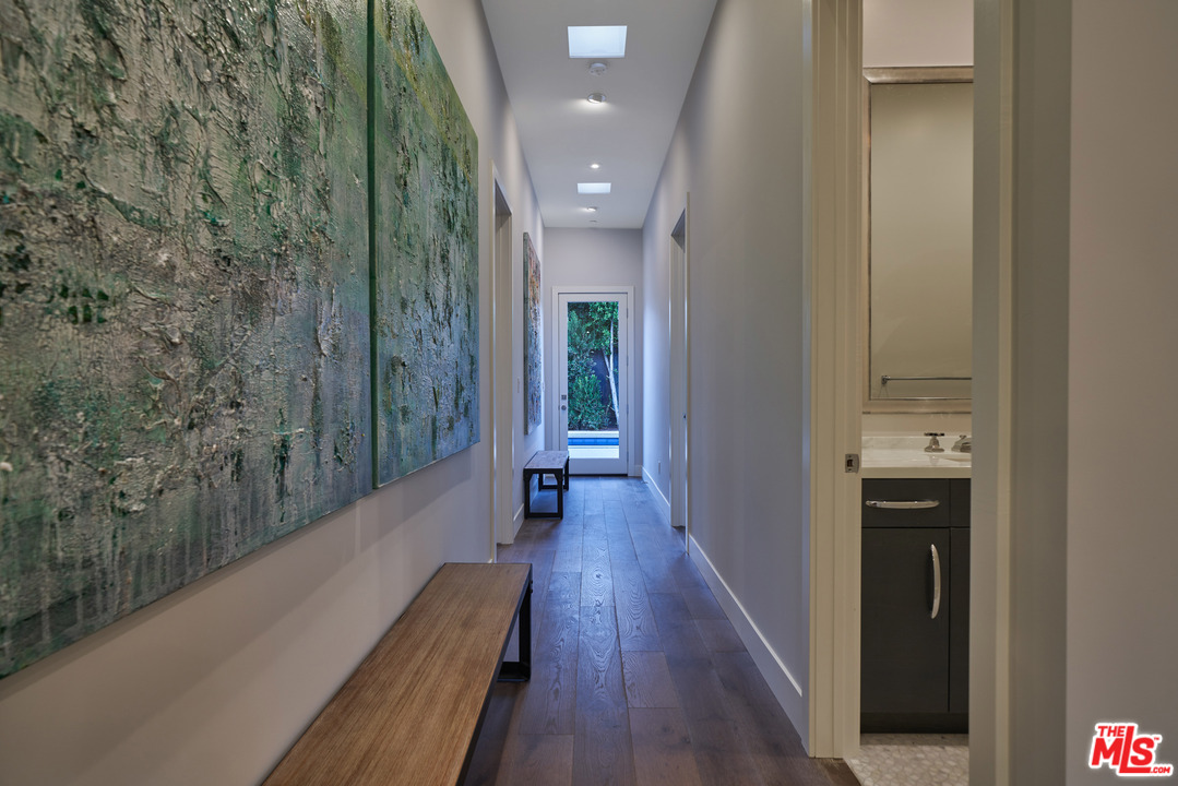 11622 Addison Street Valley Village, CA 91601 - Photo 23 of 39 a view of a hallway with wooden floor and staircase