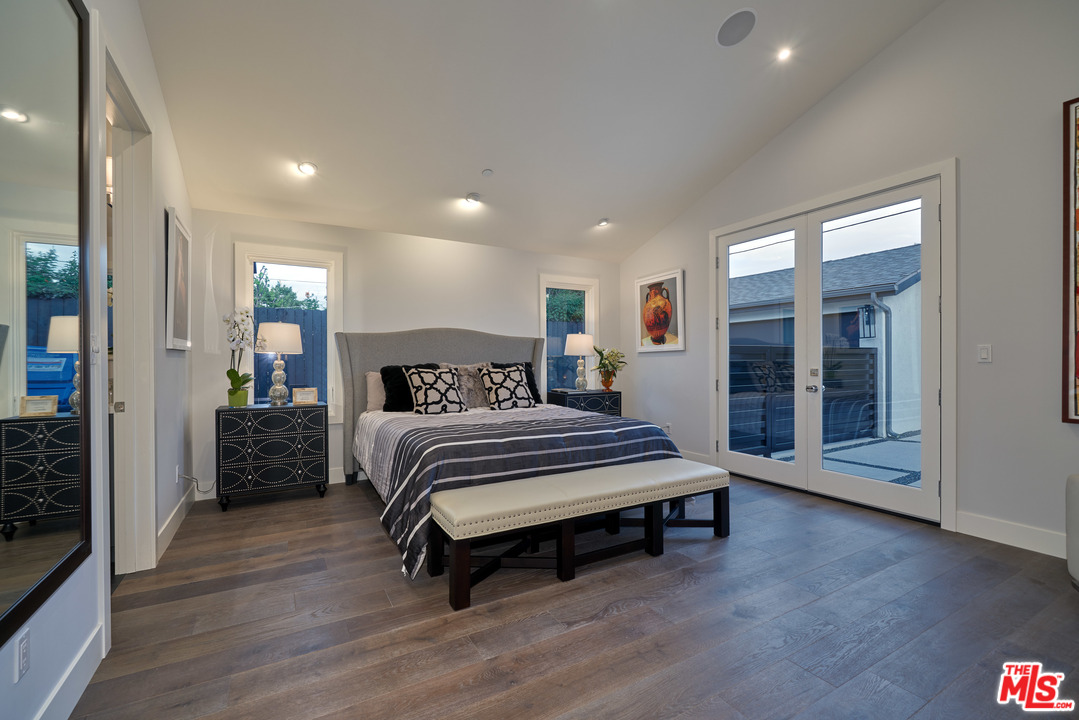 11622 Addison Street Valley Village, CA 91601 - Photo 25 of 39 a spacious bedroom with a bed and wooden floor